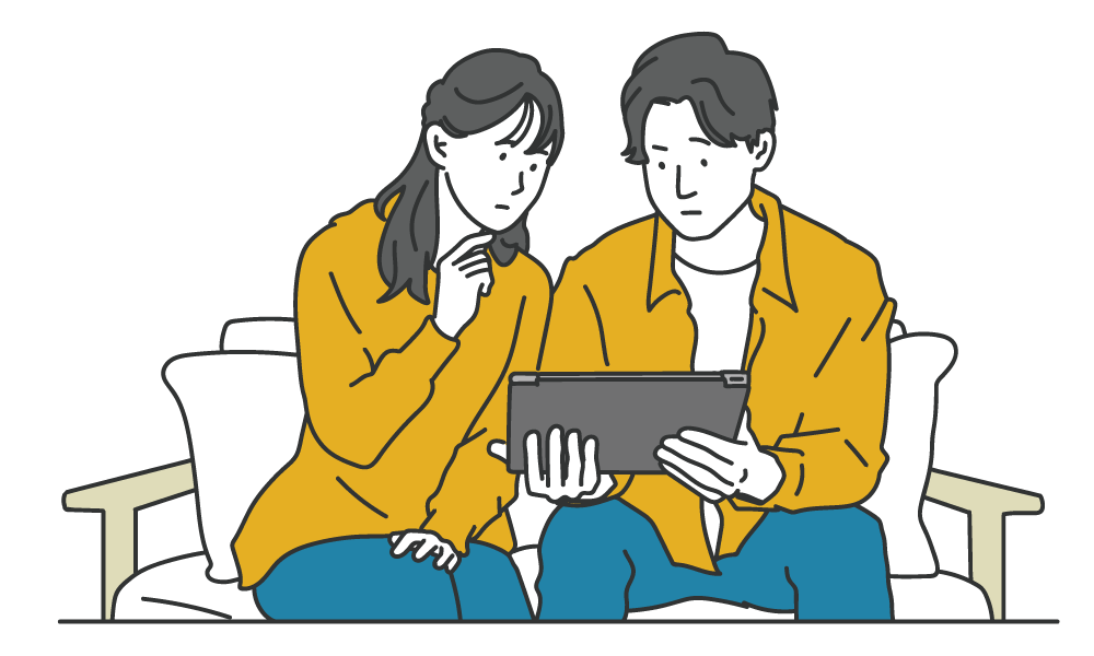 タブレットを見ながら話し合う夫婦